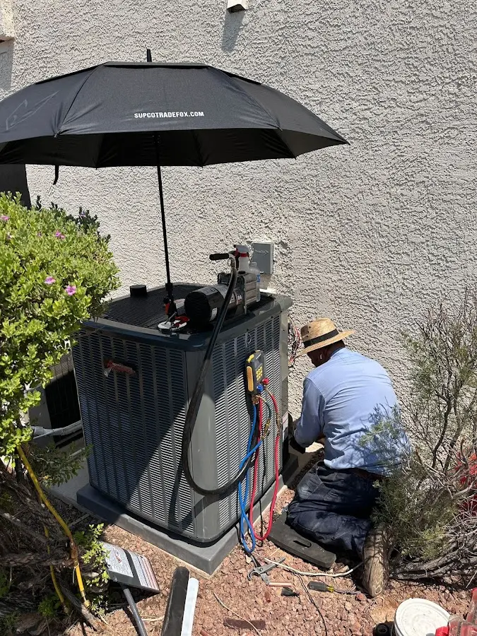 HVAC technician performing outdoor AC maintenance in Glen Ridge